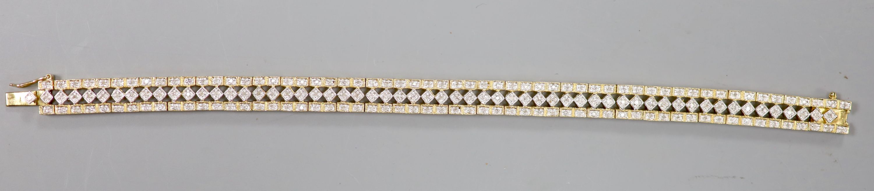 A modern pierced 9ct gold and diamond chip set line bracelet, length 18.5cm, gross 16.4 grams.